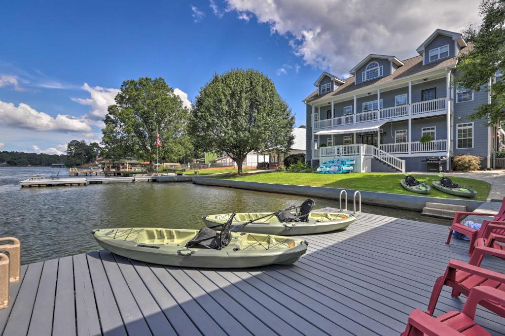 two boats sitting on a dock in front of a house at Picturesque Abode with Dock on Jackson Lake! in Jackson