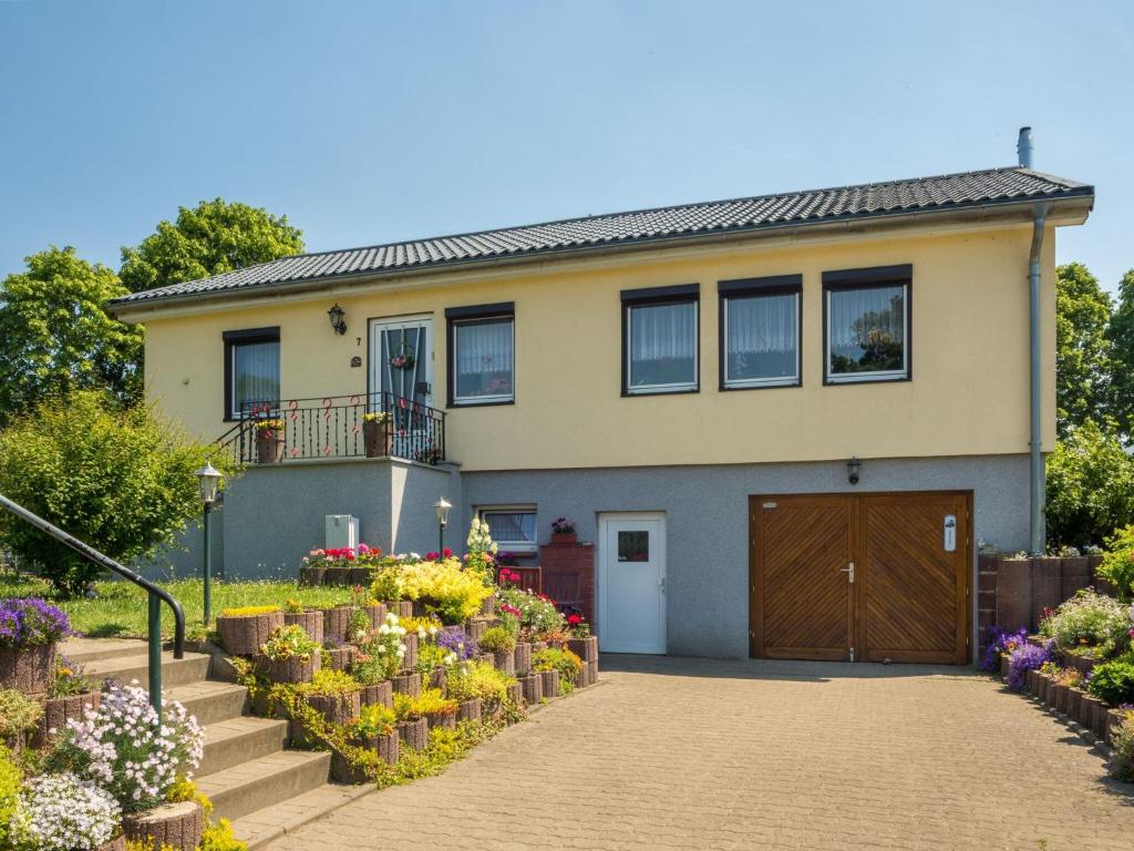 a house with a bunch of flowers in front of it at Pleasant Apartment in Damshagen with Terrace and Barbecue in Damshagen