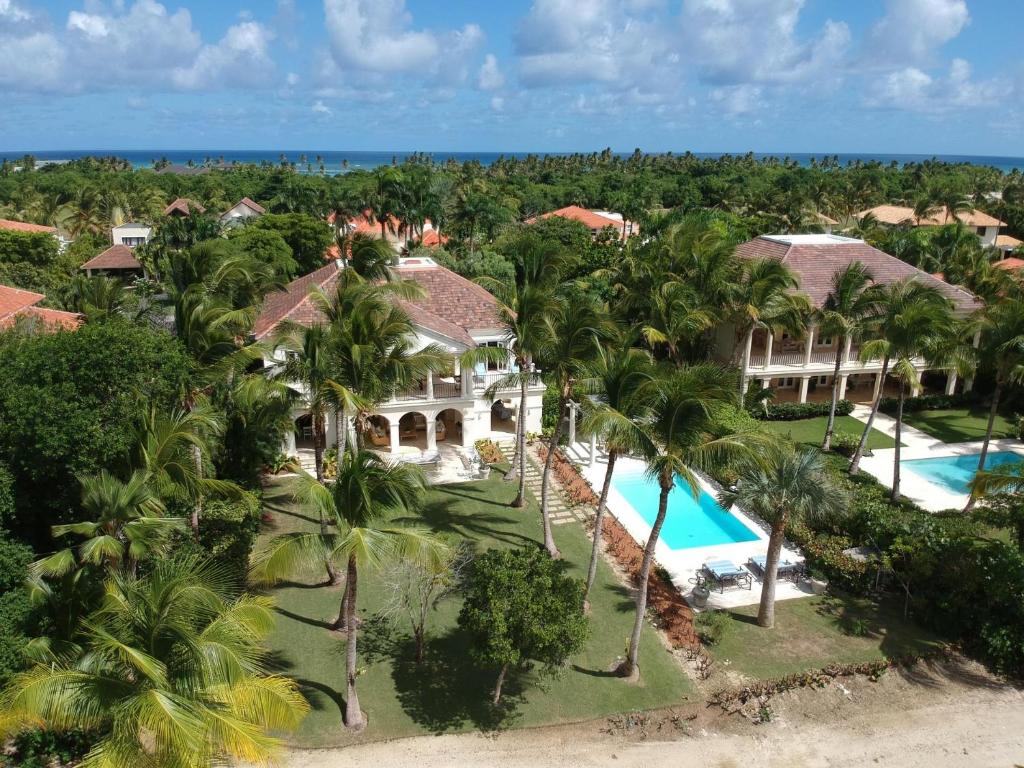 an aerial view of a resort with a pool and palm trees at Luxury golf villa with private pool and service staff in exclusive resort near private beach in Punta Cana