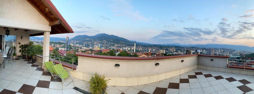 a balcony of a building with a view of a city at Apartments in villa Sabb for rent in Sarajevo