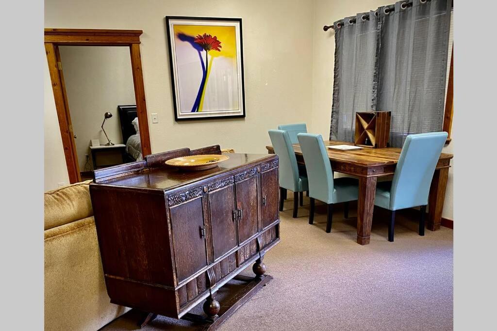 a dining room with a wooden table and blue chairs at Park Place - The Boardwalk 112-B in Darby