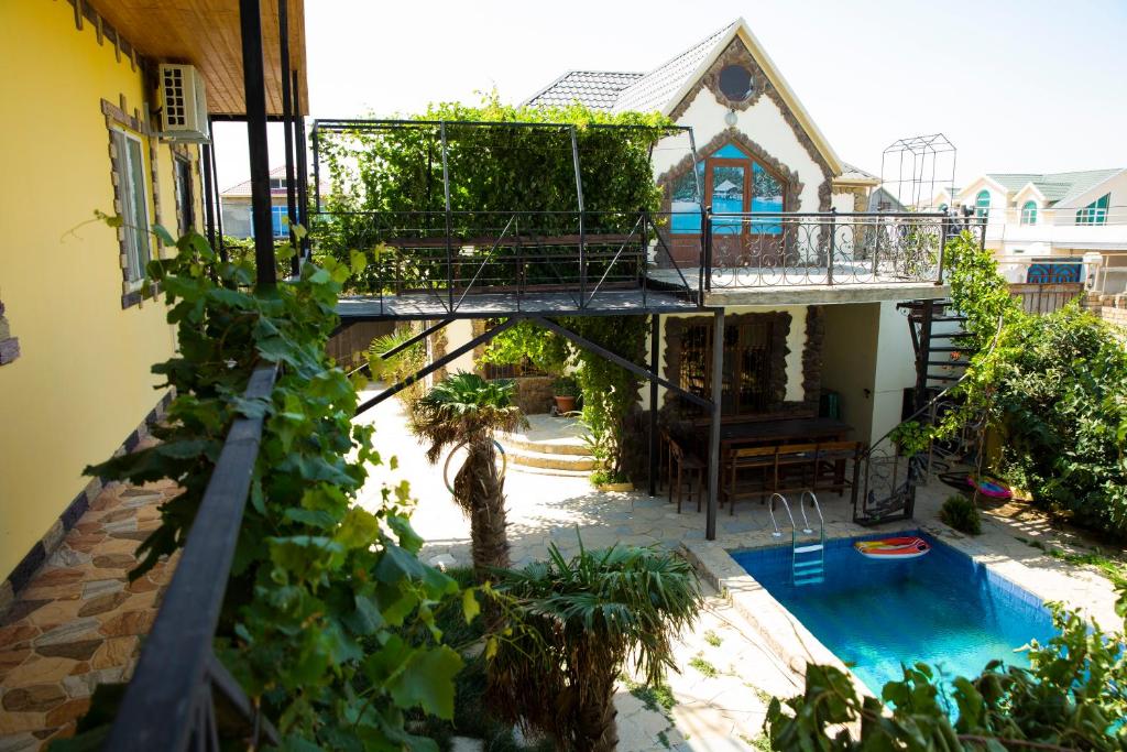 a house with a balcony and a swimming pool at Baku "Black Mountain" Guest House in Sangachal