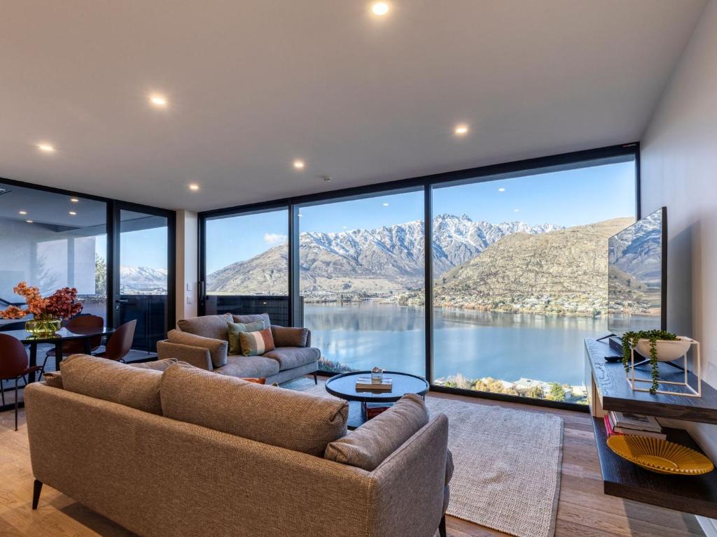 a living room with a view of a lake and mountains at The Bunker Bravo A in Queenstown