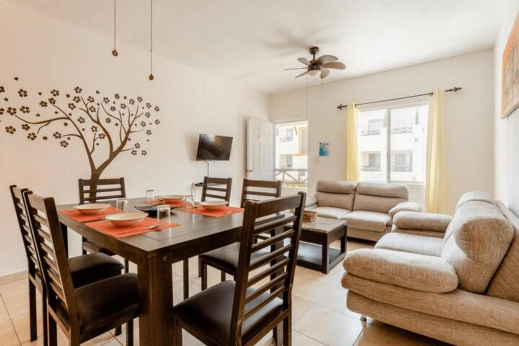 une salle à manger et un salon avec une table et des chaises dans l'établissement Apartamento En Fraccionamiento Privado 6 Personas, 5 Camas, Piscina cerca de la Playa, à Playa del Carmen