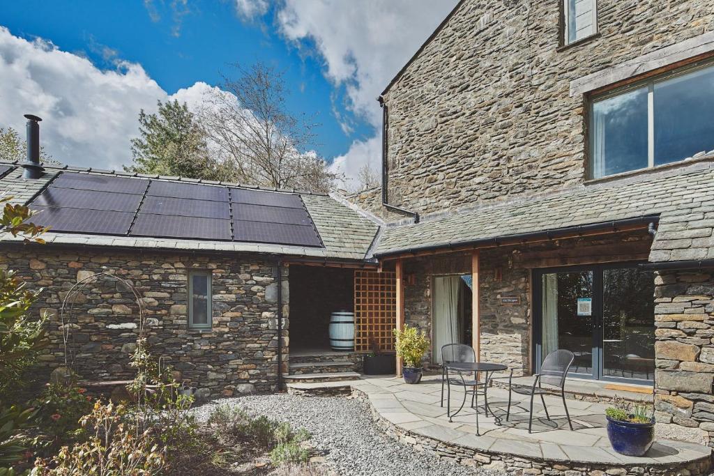 a house with solar panels on the roof at The Shippon Cottage in Kendal