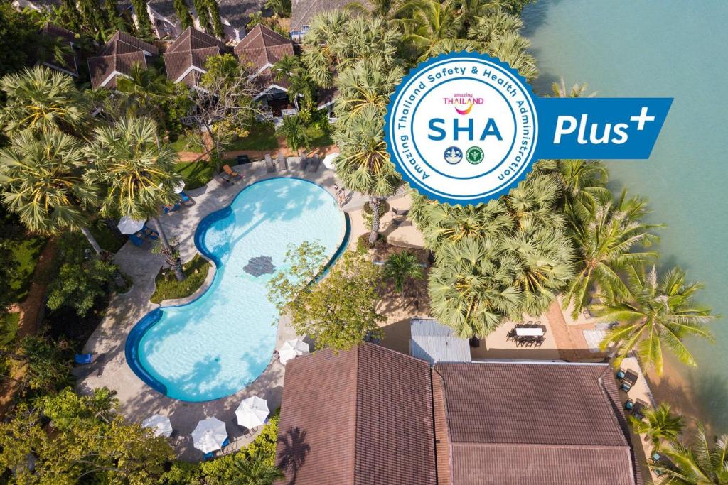 an aerial view of a resort with a pool and a sign at Paradise Beach Resort, Koh Samui - SHA Extra Plus in Mae Nam