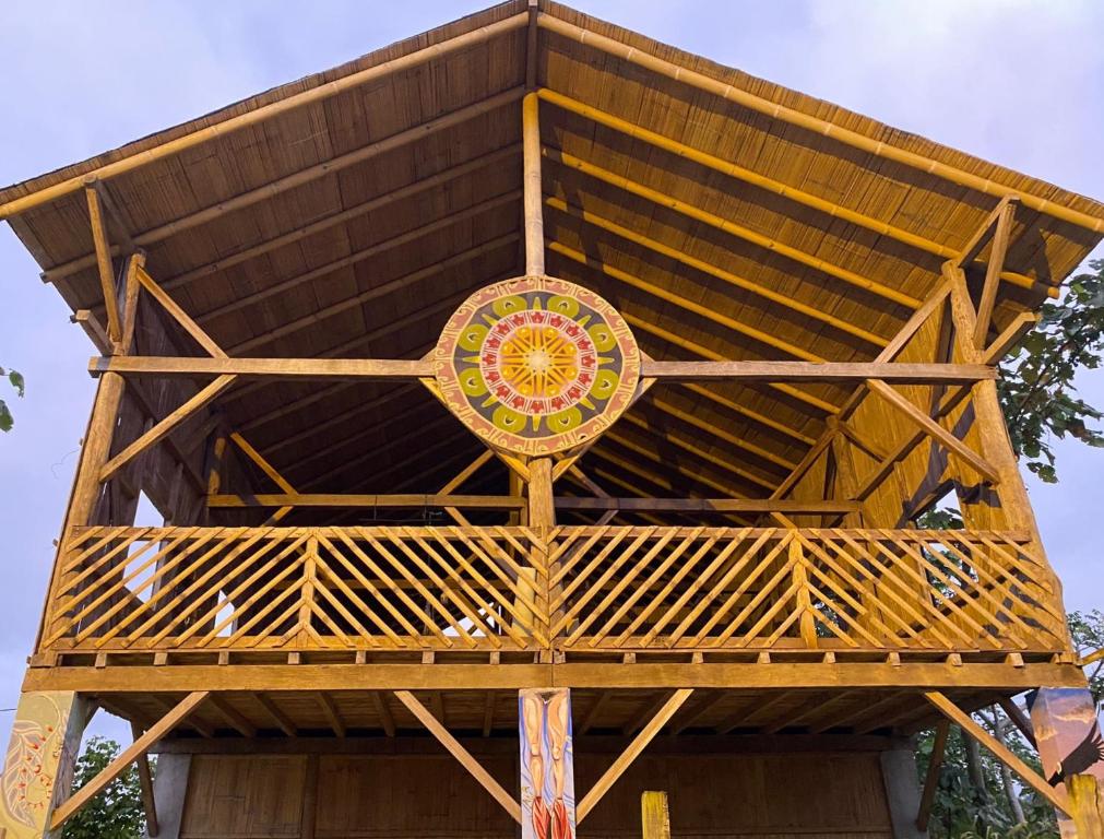 a large wooden structure with a sign on it at Hostal Camping Sin Fronteras Mompiche in Mompiche