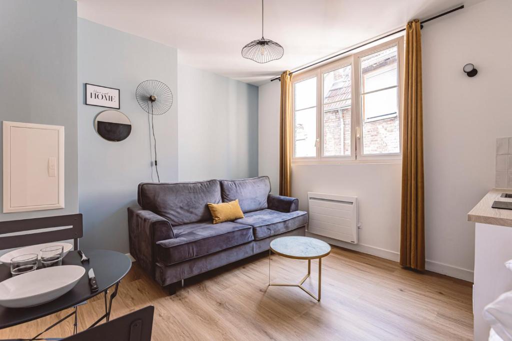 a living room with a couch and a table at Reims - City Center - Cathédrale - FORUM in Reims