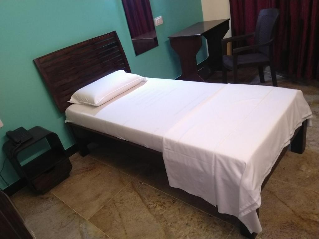 Postel nebo postele na pokoji v ubytování Chandru De Green