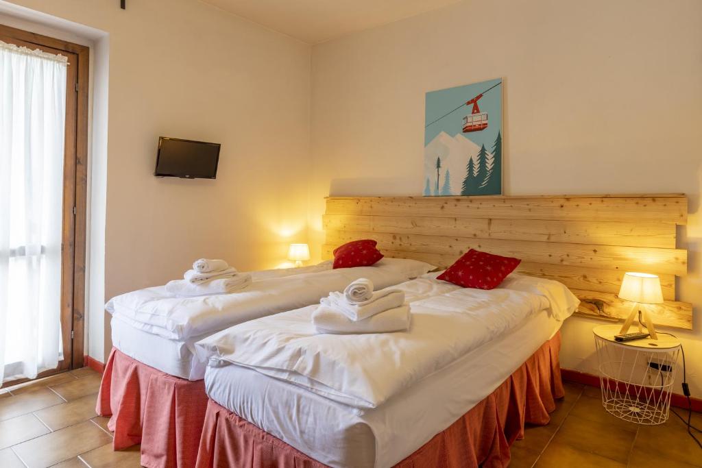 Postel nebo postele na pokoji v ubytování Aparthotel Claviere