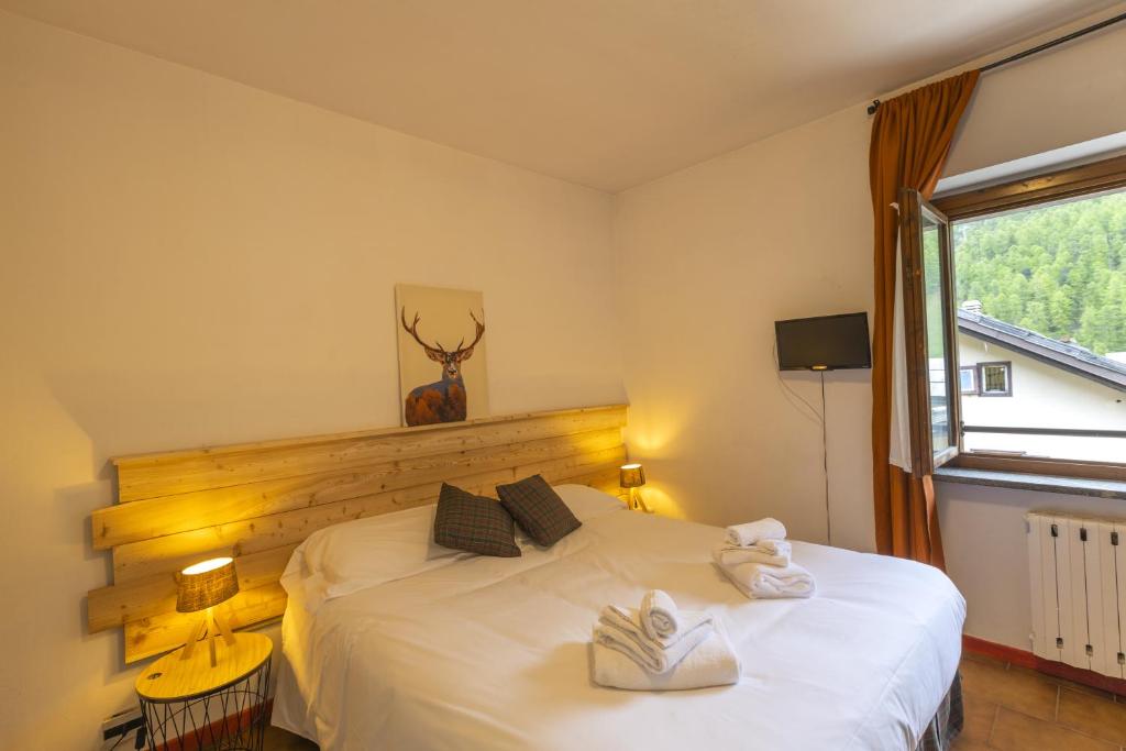 Postel nebo postele na pokoji v ubytování Aparthotel Claviere