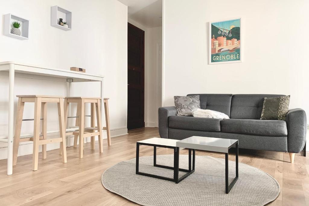 a living room with a couch and a table at 100 Grenoble #BT in Grenoble