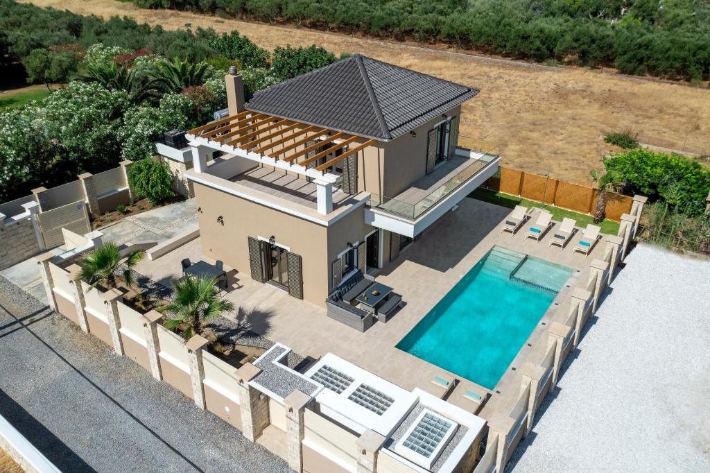 an aerial view of a house with a swimming pool at Villa Persephone in Tavronitis