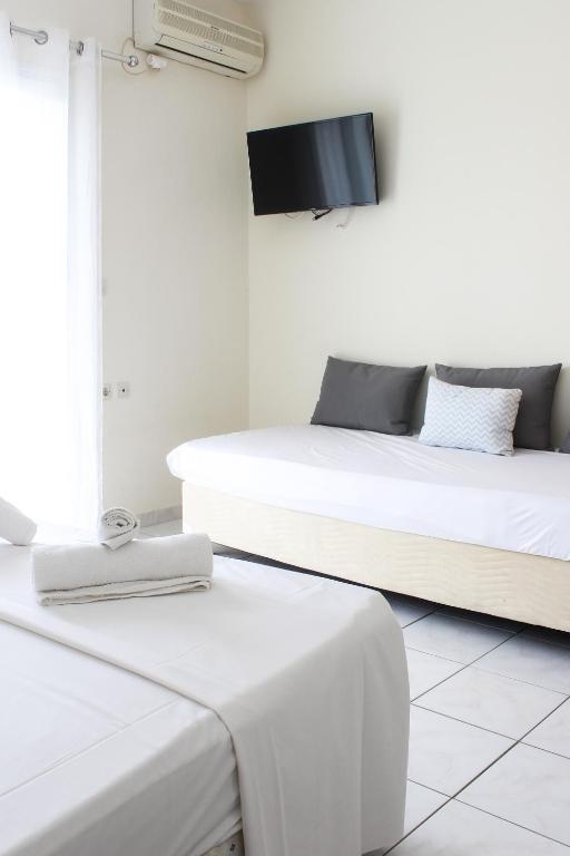 Postel nebo postele na pokoji v ubytování Iason Apartments