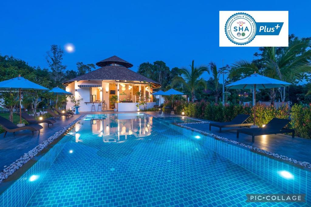 a swimming pool in a resort at night at Aonang Eco Villa - SHA Extra Plus in Ao Nang Beach