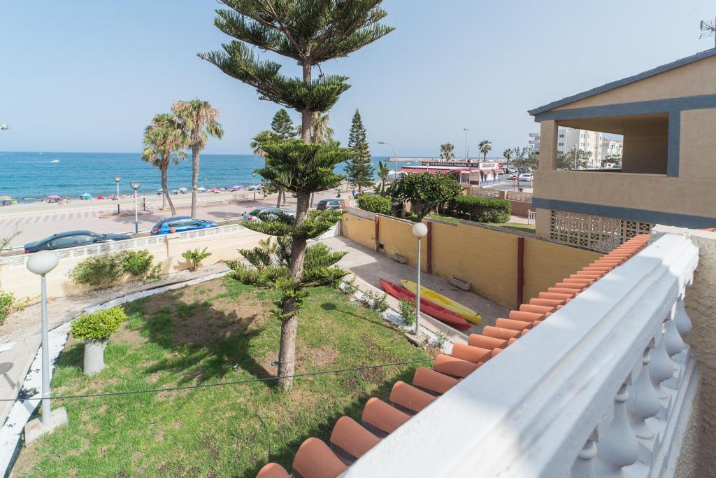 a balcony with a view of the beach and the ocean at Expoholidays-Chalet Bahari primera linea de playa in Roquetas de Mar