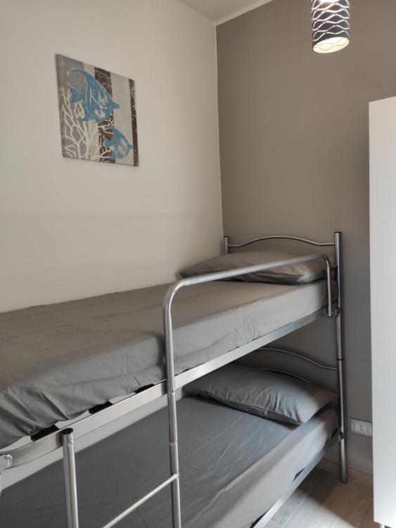 Łóżko lub łóżka w pokoju w obiekcie Antica Dogana Apartments
