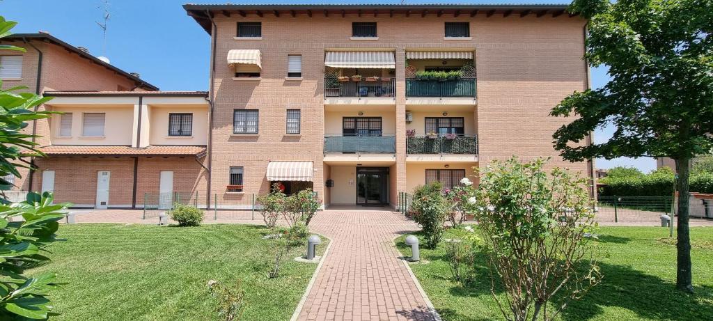 a large brick building with a walkway in front of it at GUEST HOLIDAY LIEBIG in Reggio Emilia