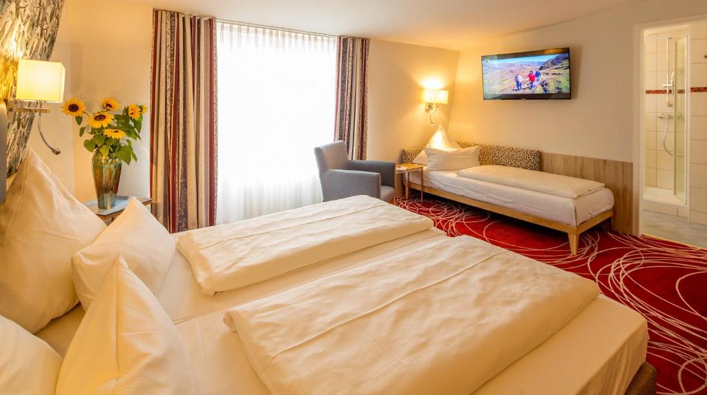 Postel nebo postele na pokoji v ubytování Hotel Löwengarten