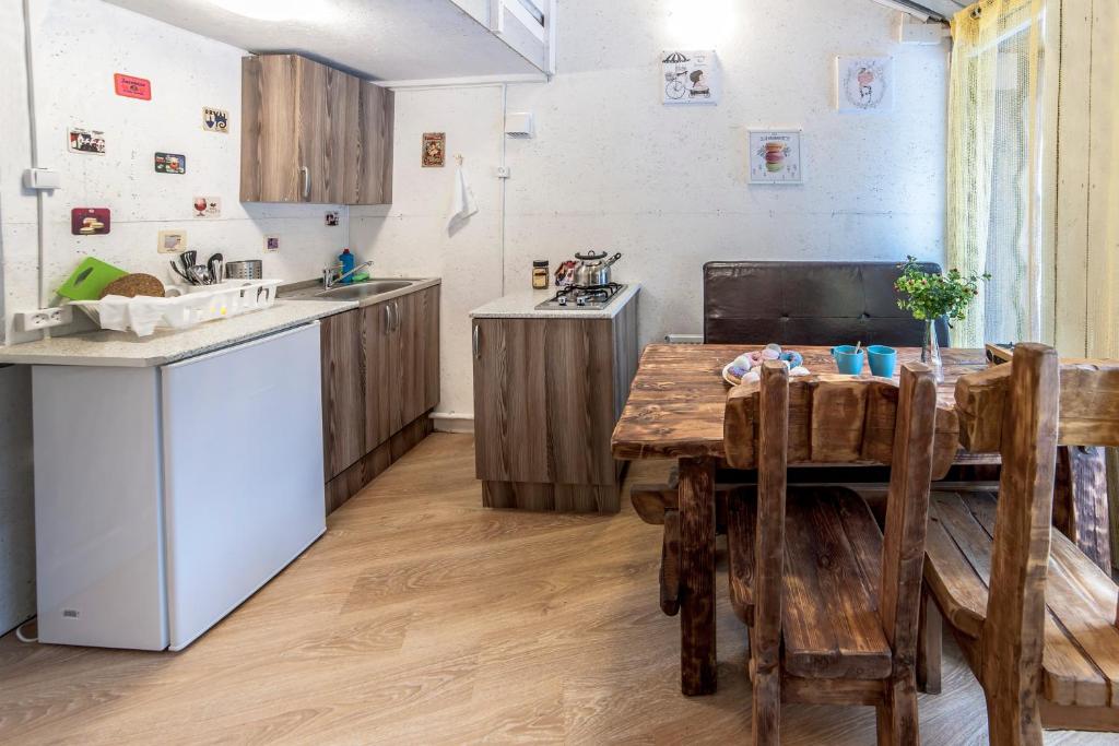 a kitchen with a wooden table and a counter top at Апарт-коттедж Princess mini in Vyborg
