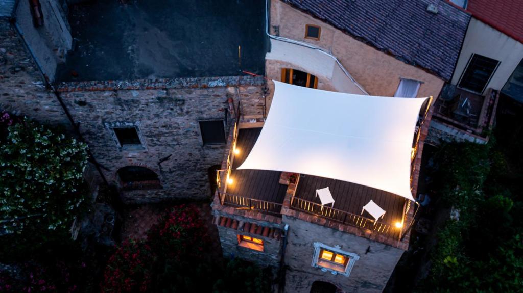 an overhead view of a building with a large white shade at NATURA rooms&sport in Finale Ligure
