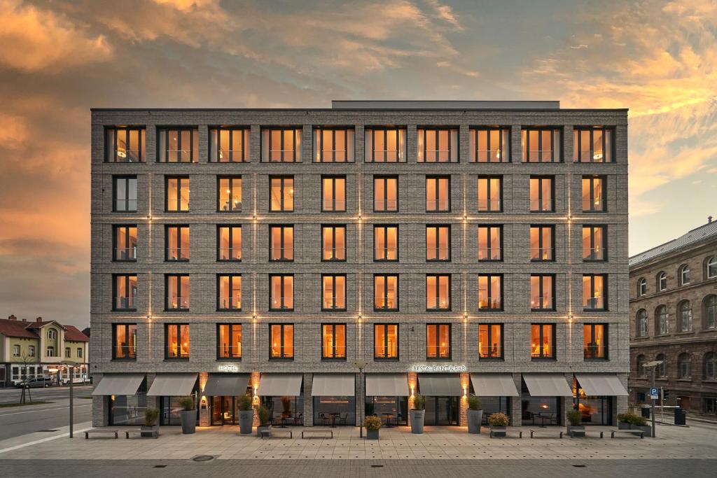 a large building with many windows in a city at FREIgeist Göttingen Innenstadt, A Member of Design Hotels in Göttingen