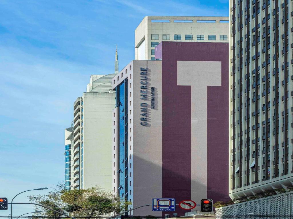 a large building with a large t sign on it at Grand Mercure Curitiba Rayon in Curitiba