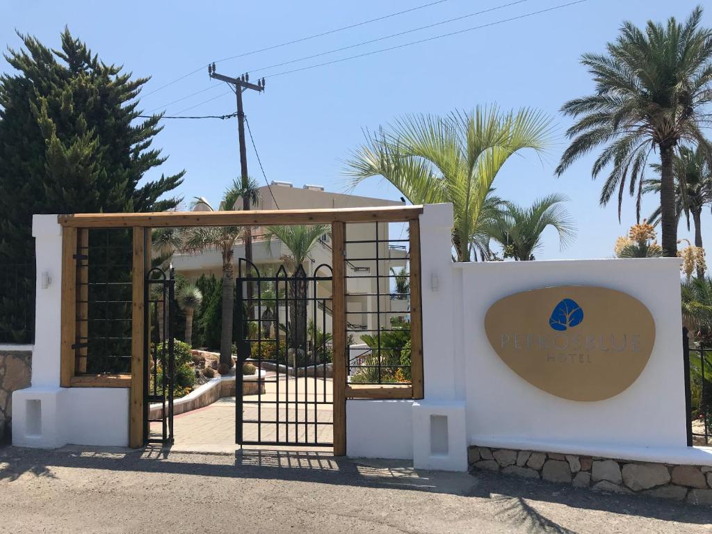a gate to a villa with palm trees at Pefkos Blue in Pefki Rhodes