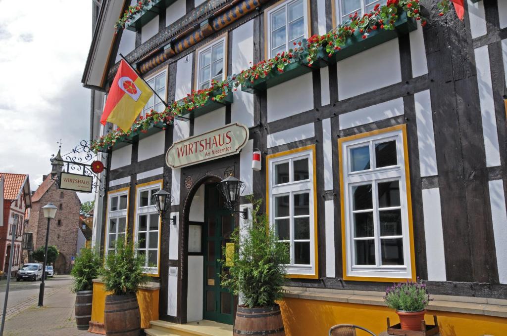 a building with a sign that reads university smiles at WIRTSHAUS am Niederntor in Blomberg