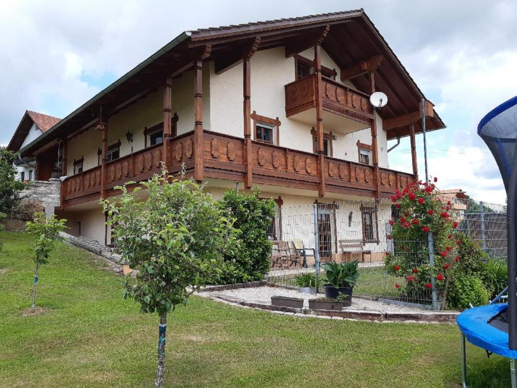 a house with a balcony on top of it at Ferienwohnung Haus am Berg in Innernzell