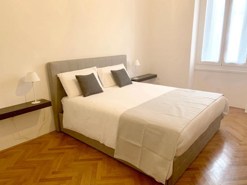 a bedroom with a large white bed with two pillows at Apartment Porto Poreč in Poreč