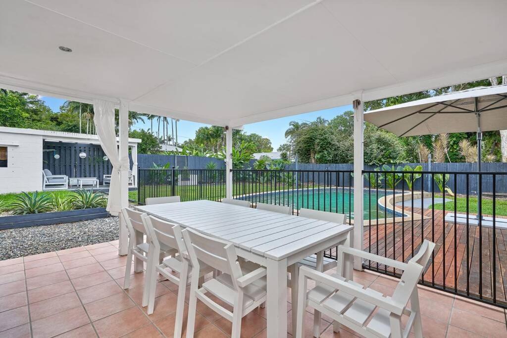a white table and chairs on a patio at Endeavour Holiday House Clifton Beach in Clifton Beach