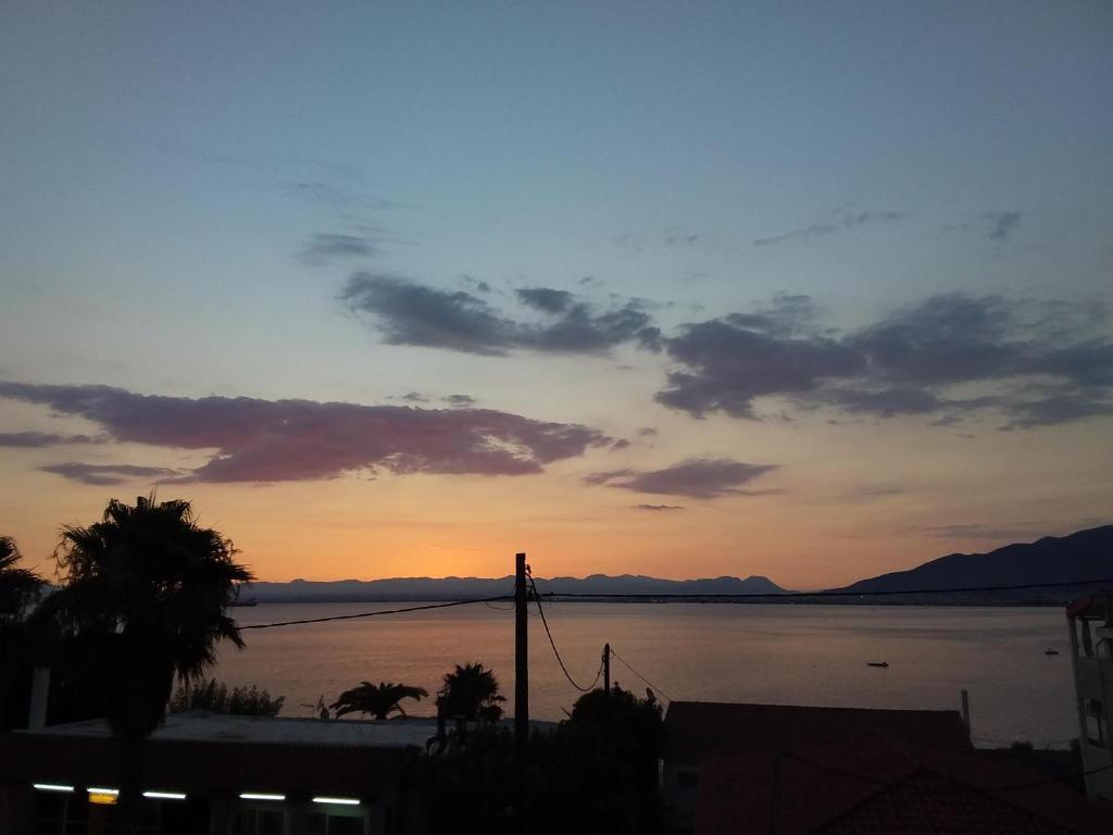 a sunset over a body of water with the sky at THALASSA ALMYROS APARTMENTS in Almirón