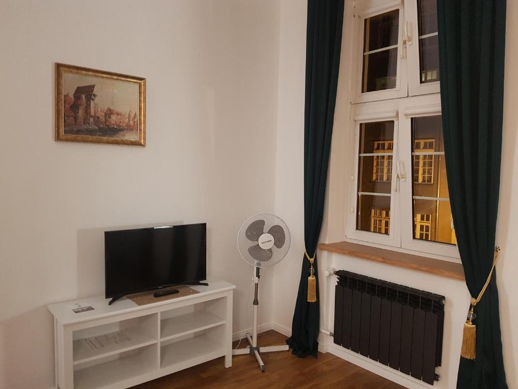 Televízia a/alebo spoločenská miestnosť v ubytovaní H&T Old Town Ogarna 97