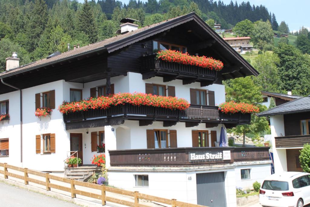 a building with flowers on the balconies of it at Haus Straif in Brixen im Thale