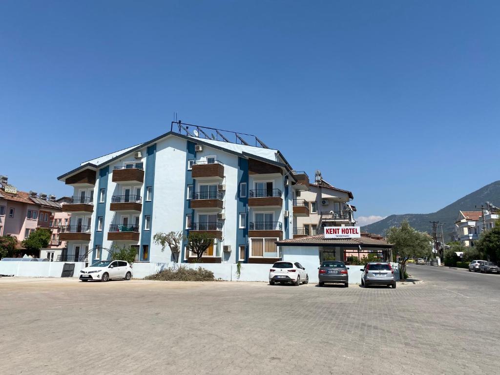 a large building with cars parked in front of it at Kent Otel in Fethiye