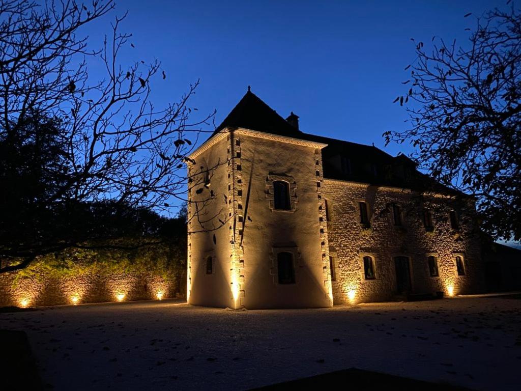 a large building with lights in front of it at night at Domaine de Cazal - Chambres d'Hôtes avec piscine au cœur de 26 hectares de nature préservée in Saint-Cyprien