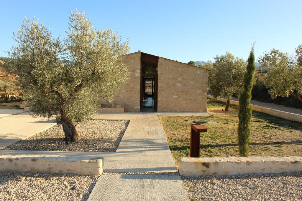 a building with two trees in front of it at Casa Oryza in Arnés