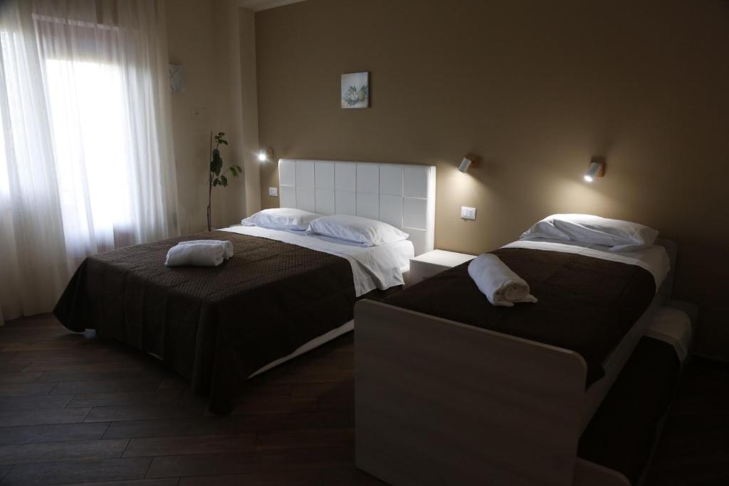 Łóżko lub łóżka w pokoju w obiekcie All’Anoneto B&B