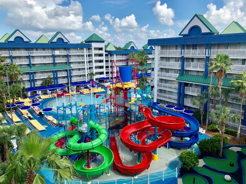 a large pool with a water slide at a resort at Holiday Inn Resort Orlando Suites - Waterpark, an IHG Hotel in Orlando