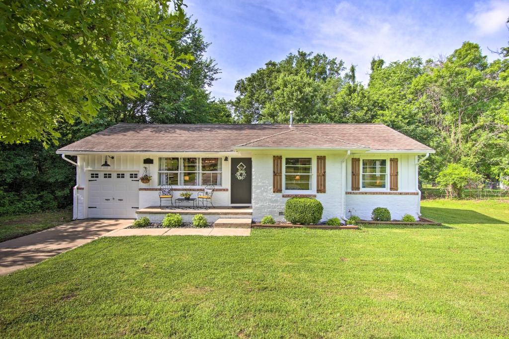 a small white house with a garage at Charming Country Cottage 5 Mi to Downtown Tulsa! in Tulsa