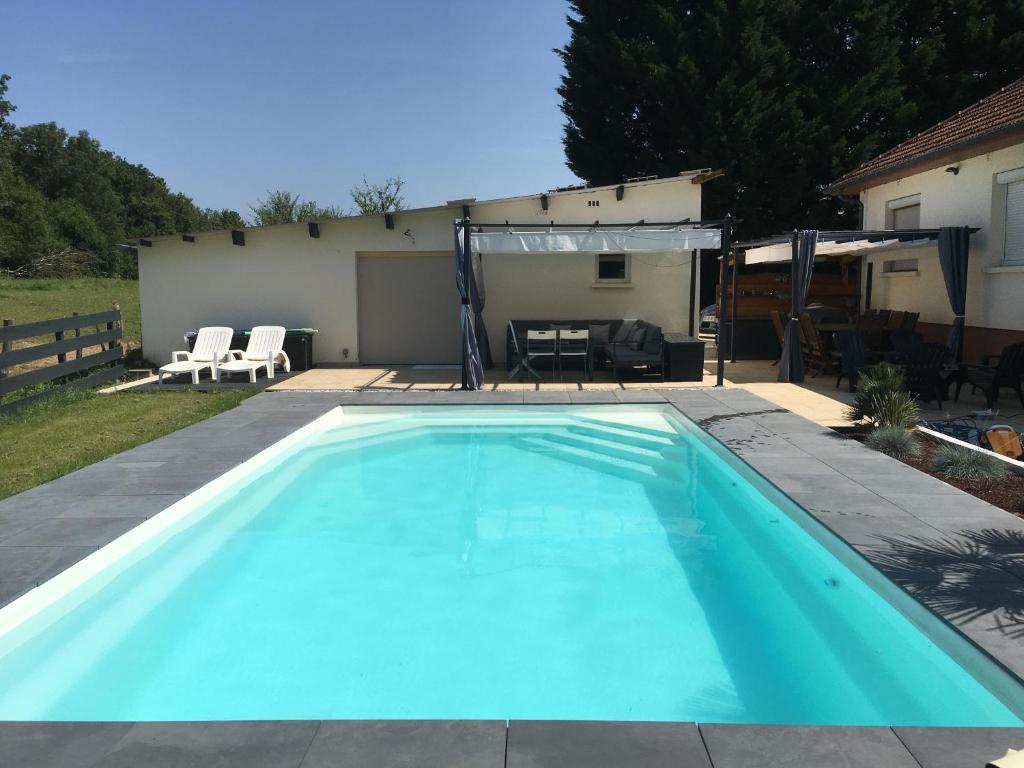 a swimming pool in the backyard of a house at La Dolce Vita in Saint-Seine-en-Bâche