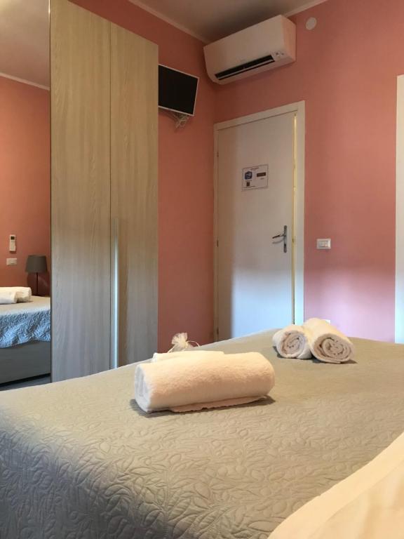 Postel nebo postele na pokoji v ubytování L'Arena Residence