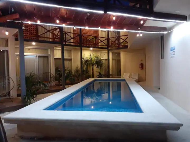 a swimming pool in the middle of a building at Kai Hotel Boutique Adults Only in Holbox Island