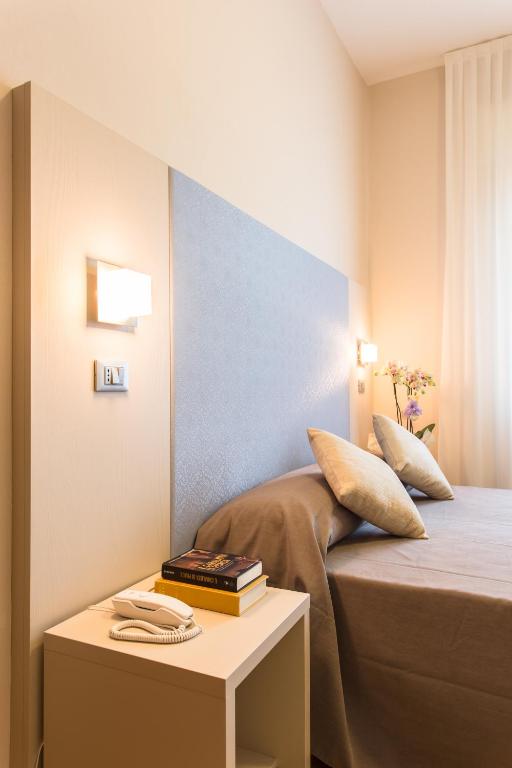 Postel nebo postele na pokoji v ubytování New Hotel Chiari