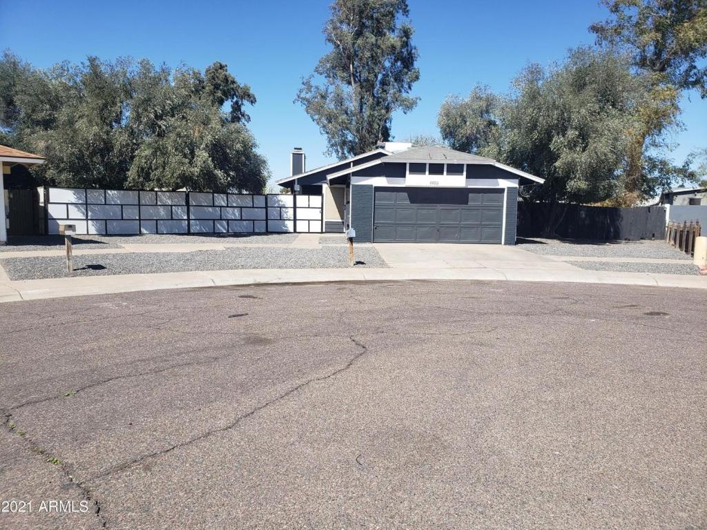 a house with a garage and a driveway at Shared living NOT A HOTEL in Phoenix