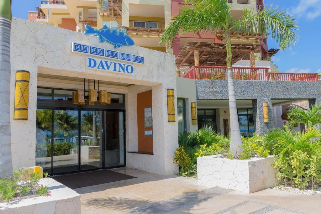a hotel with a palm tree in front of a building at Villa del Palmar Cancun Luxury Beach Resort & Spa in Cancún