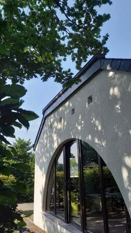 a building with a window on the side of it at Maison des M in Houffalize
