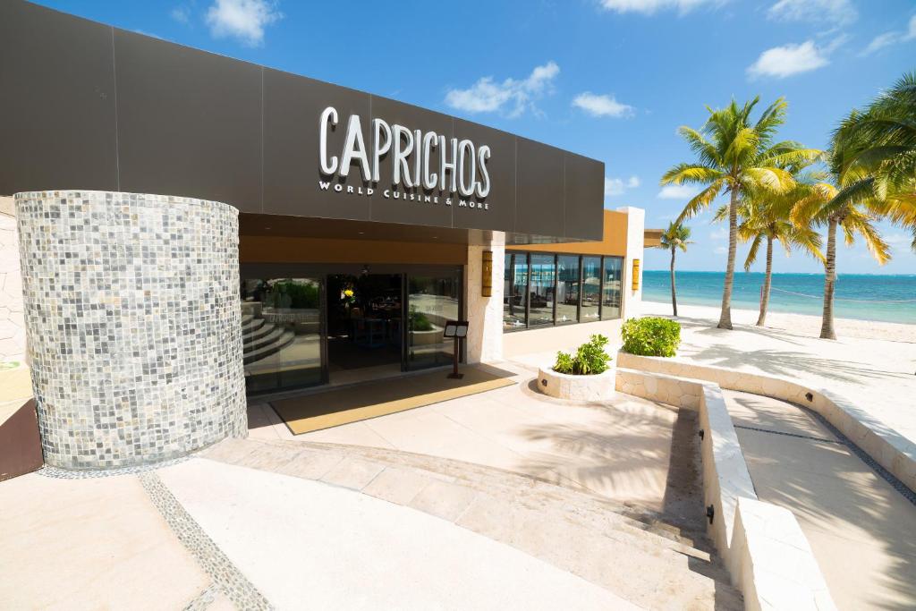 a store on the beach with palm trees and the ocean at Villa del Palmar Cancun Luxury Beach Resort & Spa in Cancún