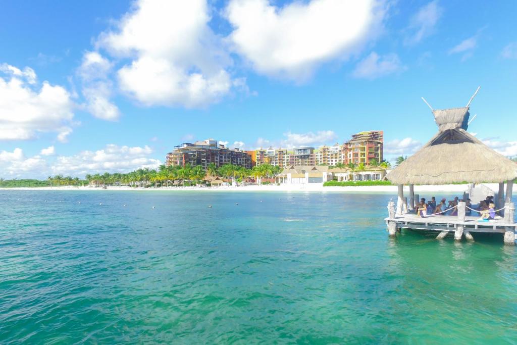 a pier with a group of people on it in the water at Villa del Palmar Cancun Luxury Beach Resort & Spa in Cancún